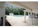 Covered pool area with a large pool, lounge chairs, and a nearby pool house at 1431 Beckett Dr, Hampton, GA 30228