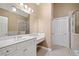 Bright bathroom vanity with white cabinetry, granite counters, and a framed mirror at 255 Kendemere Pointe, Roswell, GA 30075