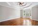 Bright bedroom with tray ceilings, hardwood floors, and a bay window with plantation shutters at 255 Kendemere Pointe, Roswell, GA 30075