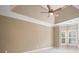 Bright bedroom with a tray ceiling, ceiling fan and shuttered windows at 255 Kendemere Pointe, Roswell, GA 30075