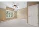 Bedroom featuring neutral walls, carpet, ceiling fan, and a shuttered window at 255 Kendemere Pointe, Roswell, GA 30075