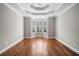Bedroom with neutral walls, wood floors, and a bay window with shuttered blinds at 255 Kendemere Pointe, Roswell, GA 30075