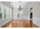 Dining room featuring shuttered windows, chandelier, trimwork and hardwood floors at 255 Kendemere Pointe, Roswell, GA 30075