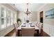 Elegant dining room with hardwood floors, plantation shutters, and a classic chandelier at 255 Kendemere Pointe, Roswell, GA 30075