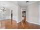 Bright dining room with hardwood floors, chandelier, and views of other rooms at 255 Kendemere Pointe, Roswell, GA 30075