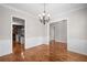 Open dining area with hardwood floors, chandelier, and views of kitchen and living areas at 255 Kendemere Pointe, Roswell, GA 30075