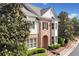 Charming brick home with manicured landscaping, symmetrical design, and a welcoming arched entryway at 255 Kendemere Pointe, Roswell, GA 30075
