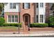 Charming brick home with manicured landscaping, symmetrical design, and a welcoming arched entryway at 255 Kendemere Pointe, Roswell, GA 30075
