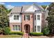 Charming brick home with manicured landscaping, symmetrical design, and a welcoming arched entryway at 255 Kendemere Pointe, Roswell, GA 30075