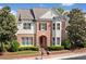 Charming brick home with manicured landscaping, symmetrical design, and a welcoming arched entryway at 255 Kendemere Pointe, Roswell, GA 30075