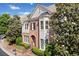 Charming brick home with manicured landscaping, symmetrical design, and a welcoming arched entryway at 255 Kendemere Pointe, Roswell, GA 30075