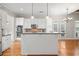 Bright kitchen with white cabinets, stainless steel appliances, and a center island with pendant lighting at 255 Kendemere Pointe, Roswell, GA 30075