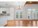 Open kitchen and dining area with stainless appliances, hardwood floors, and bright windows at 255 Kendemere Pointe, Roswell, GA 30075