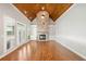 Bright living room with soaring ceiling, wood beams, and stone fireplace with built in shelving at 255 Kendemere Pointe, Roswell, GA 30075