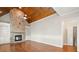 Spacious living room with stone fireplace, wood ceiling and built in bookshelves at 255 Kendemere Pointe, Roswell, GA 30075