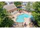 A picturesque community pool with ample seating and landscaping and umbrellas at 255 Kendemere Pointe, Roswell, GA 30075