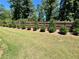 Grassy backyard with small shrubbery along a wood fence, creating a private outdoor space at 3165 Blackshear Dr, Marietta, GA 30060