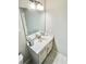 Bright bathroom with white vanity, large mirror and modern light fixture at 3165 Blackshear Dr, Marietta, GA 30060