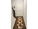 Hallway with wood floors, staircase, decorative rug and white door to the garage at 3165 Blackshear Dr, Marietta, GA 30060