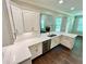 Well-equipped kitchen with white countertops and cabinets, stainless steel appliances, and hardwood floors at 3165 Blackshear Dr, Marietta, GA 30060