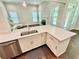 Kitchen island with quartz countertops, stainless steel dishwasher, and view of the bright living room at 3165 Blackshear Dr, Marietta, GA 30060