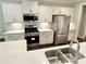 Bright kitchen featuring stainless steel appliances, white cabinets, and a double sink with modern faucet at 3165 Blackshear Dr, Marietta, GA 30060