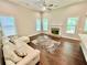 Spacious living room with hardwood floors, a fireplace, and a comfortable white sectional sofa at 3165 Blackshear Dr, Marietta, GA 30060