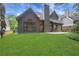 Backyard view of the property with green grass and neutral exterior at 2255 Lenox Ridge Ne Ct, Atlanta, GA 30319