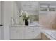 Stylish bathroom vanity featuring white cabinetry and dual sinks below a large mirror at 2255 Lenox Ridge Ne Ct, Atlanta, GA 30319