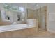 Bright bathroom showcasing a soaking tub and glass-enclosed shower with tiled walls at 2255 Lenox Ridge Ne Ct, Atlanta, GA 30319