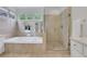 Bright bathroom showcasing a soaking tub and glass-enclosed shower with tiled walls at 2255 Lenox Ridge Ne Ct, Atlanta, GA 30319