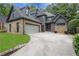 Stunning home features a stone facade, a gray color scheme and attached two-car garage at 2255 Lenox Ridge Ne Ct, Atlanta, GA 30319