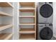 Laundry area with modern washer and dryer units and shelving for storage at 2255 Lenox Ridge Ne Ct, Atlanta, GA 30319