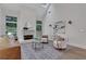 Bright living room featuring fireplace, high ceilings, hardwood floors, and a ceiling fan at 2255 Lenox Ridge Ne Ct, Atlanta, GA 30319