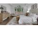 Bright main bedroom with a window view, wooden dresser, and accent chair at 2255 Lenox Ridge Ne Ct, Atlanta, GA 30319
