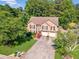 Aerial front view showcasing a well-maintained lawn, landscaping, and a two-car garage at 435 Flowering Trl, Grayson, GA 30017