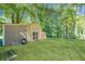 Storage barn with grassy yard and mature trees at 435 Flowering Trl, Grayson, GA 30017
