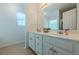 Clean bathroom with double sinks, tile flooring, and a large mirror at 435 Flowering Trl, Grayson, GA 30017