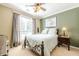 Inviting bedroom with a metal-frame bed, ceiling fan, and soft natural light from the window at 435 Flowering Trl, Grayson, GA 30017