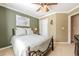 Well-lit bedroom featuring a metal-frame bed, complemented by warm tones and a ceiling fan at 435 Flowering Trl, Grayson, GA 30017