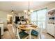Bright and airy dining area featuring a round table, white cabinets, and a large window at 435 Flowering Trl, Grayson, GA 30017