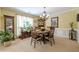 This elegant dining room includes a wooden table with seating for six, and natural light from the window at 435 Flowering Trl, Grayson, GA 30017