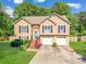 Attractive two-story home with a well-kept lawn, brick accents, and a double garage at 435 Flowering Trl, Grayson, GA 30017