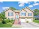 Charming two-story home featuring a brick-accented entrance, tidy lawn, and a two-car garage at 435 Flowering Trl, Grayson, GA 30017