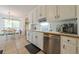 Clean kitchen featuring stainless steel appliances, lots of white cabinets, and a view of the dining area at 435 Flowering Trl, Grayson, GA 30017