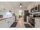Well-equipped kitchen with stainless steel appliances, ample counter space, and tile flooring at 435 Flowering Trl, Grayson, GA 30017