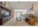 Spacious living room with a large TV, comfortable seating, and an open staircase at 435 Flowering Trl, Grayson, GA 30017