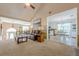 Open-concept living room flows into the dining area, with a leather sofa and neutral decor at 435 Flowering Trl, Grayson, GA 30017