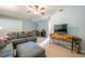 Comfortable living room with soft decor, plush seating, ceiling fan, and neutral carpet at 435 Flowering Trl, Grayson, GA 30017