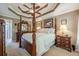 Spacious main bedroom with a four-poster bed, tray ceiling, and traditional-style furniture at 435 Flowering Trl, Grayson, GA 30017